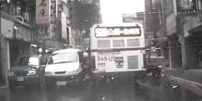 فيديو: دراج يحاول المرور بين سيارة وحافلة فيعلق في المنتصف